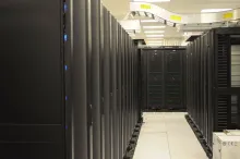 Rows of server racks inside a data center, photographed at the National Energy Research Scientific Computing Center.