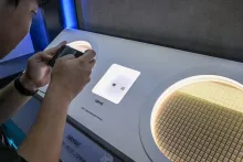 A visitor photographs Samsung's HBM4E display and wafer at SEDEX 2026 in Seoul.