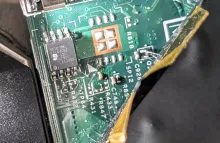 Close-up photograph of an MXIC BIOS chip on a green ThinkPad X220 motherboard.