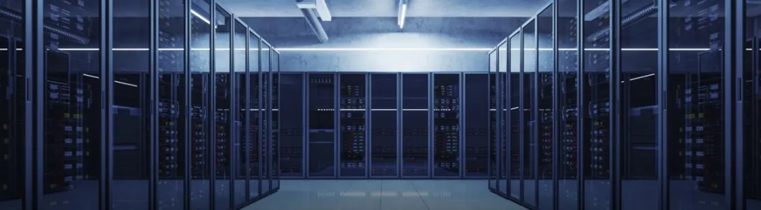 A data center server room with rows of glass-fronted server racks.