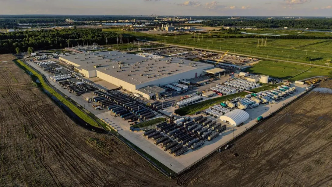 Aerial photograph of the xAI Colossus data center in Memphis, surrounded by rows of cooling and power equipment.