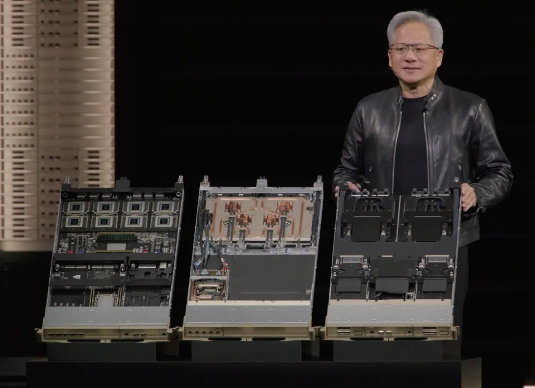 Nvidia CEO Jensen Huang on stage at GTC 2026 standing beside Vera Rubin server trays and a rack system.