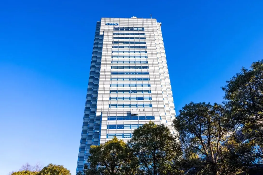 The GMO Internet Tower in Tokyo, headquarters of GMO Internet Group, photographed against a clear blue sky.