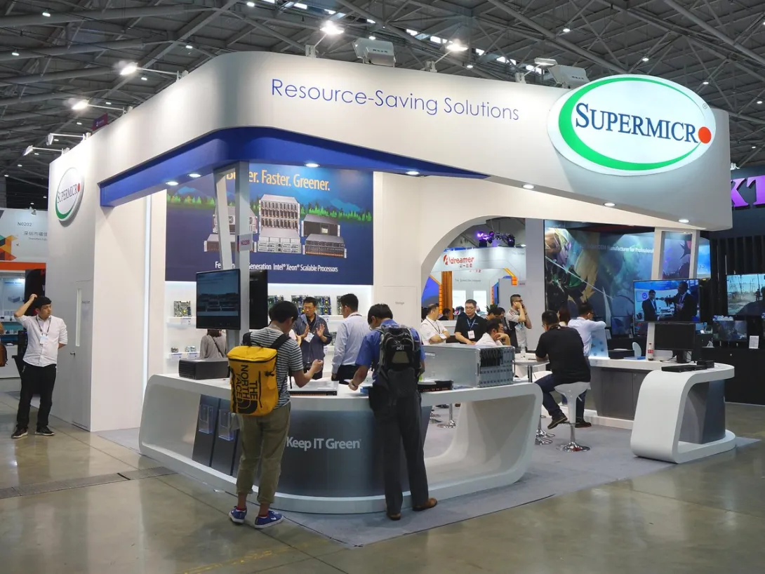 The Supermicro booth at Computex Taipei, with visitors examining server systems on display.