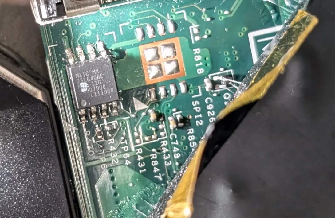 Close-up photograph of an MXIC BIOS chip on a green ThinkPad X220 motherboard.